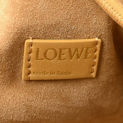 Loewe leather patch label inside tan clutch