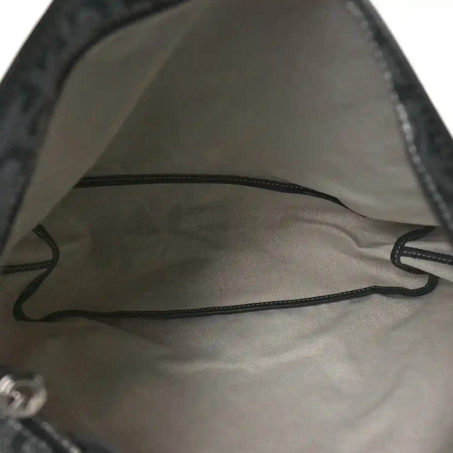 Grey fabric-lined hobo bag interior with drawstring cord detail