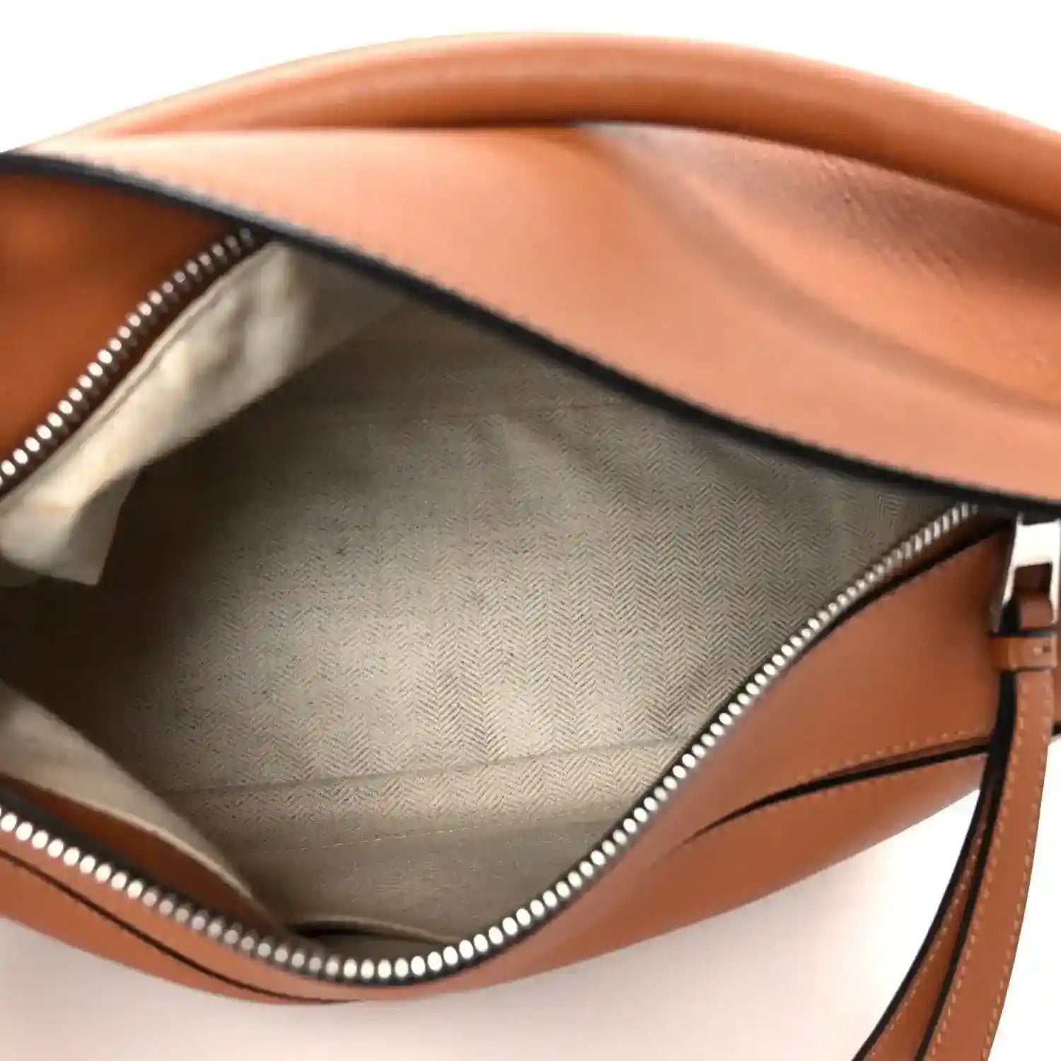 Loewe tan calfskin small Puzzle shoulder bag interior with zip-top opening