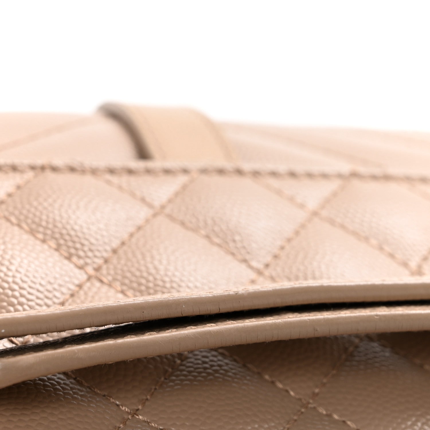 Dark beige quilted satchel strap top edge with neat stitching