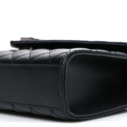 Black quilted leather satchel side edge with rounded corner and smooth border
