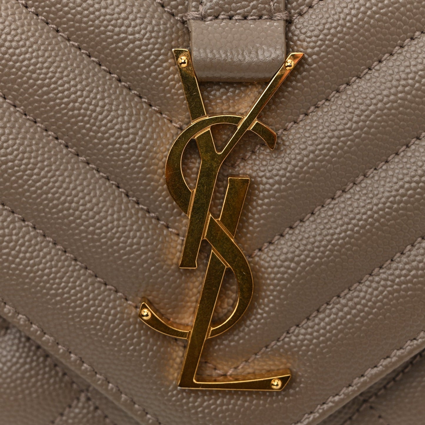 Gold YSL monogram on quilted satchel flap