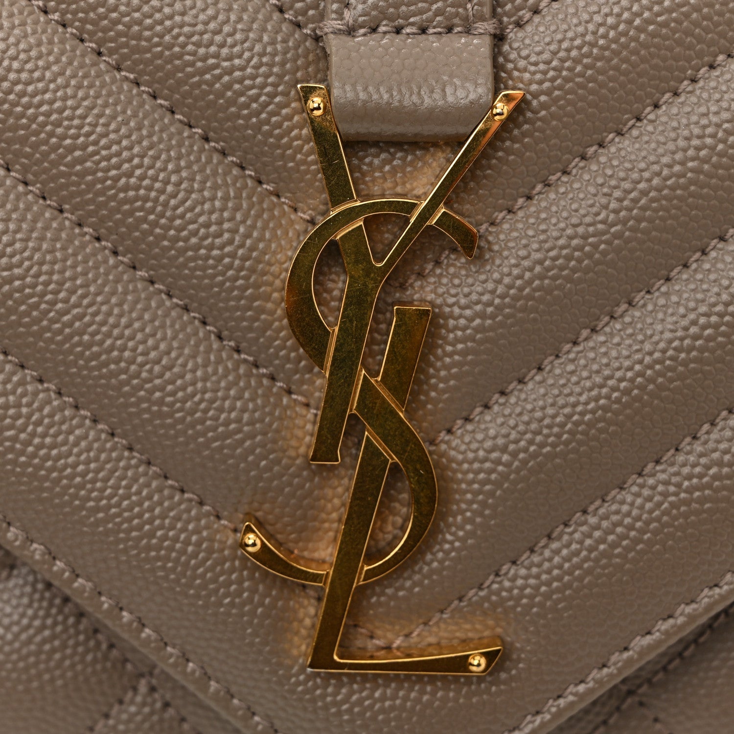 Gold YSL monogram on quilted satchel flap