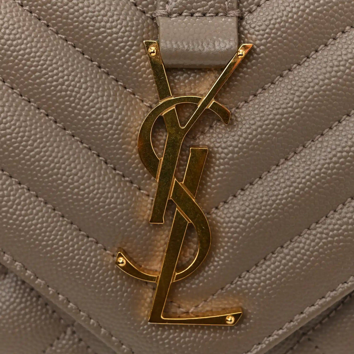 Gold YSL monogram on quilted satchel flap