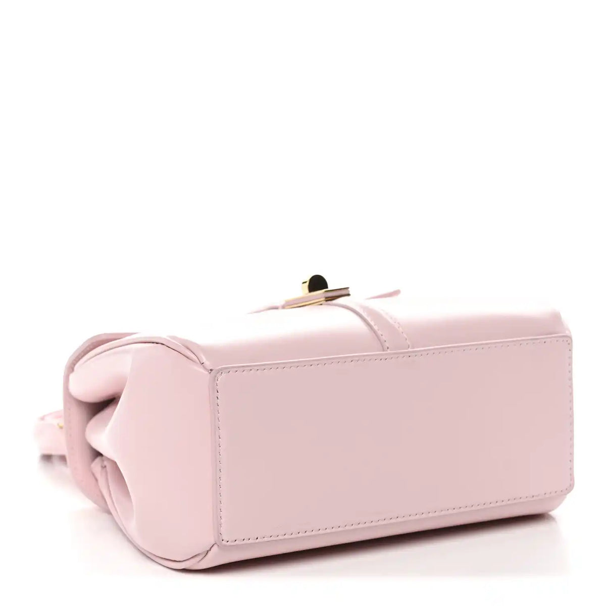 Pastel pink mini top-handle bag with back panel, rolled handle, and gold top clasp