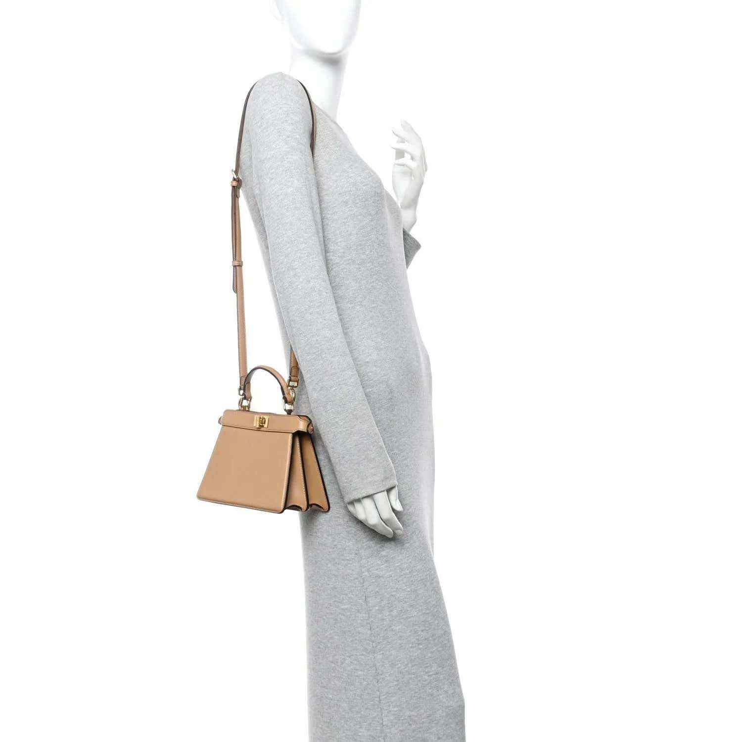 Tan mini satchel worn on shoulder with short strap and gold-tone hardware