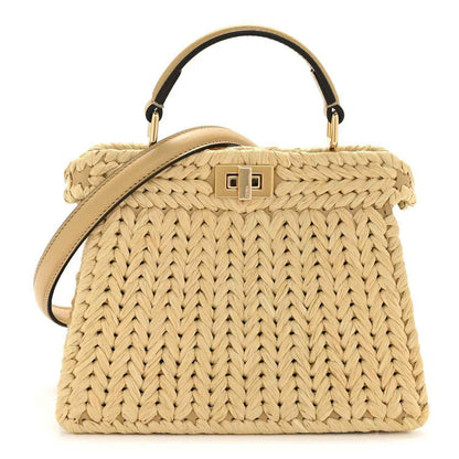 Petite raffia satchel bag with tan leather handles and gold-tone front clasp detail.
