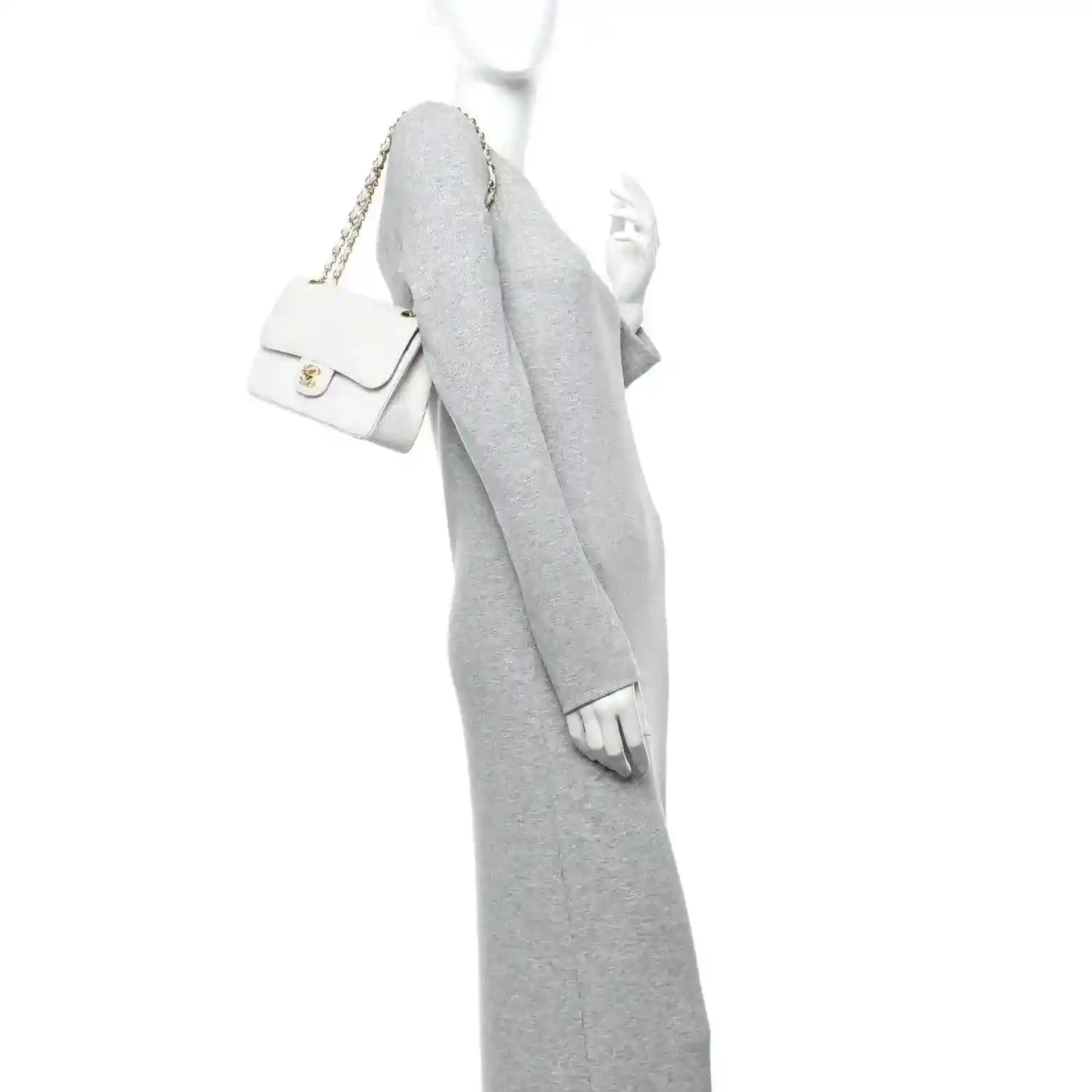 White leather mini shoulder bag with gold chain strap and flap, worn crossbody