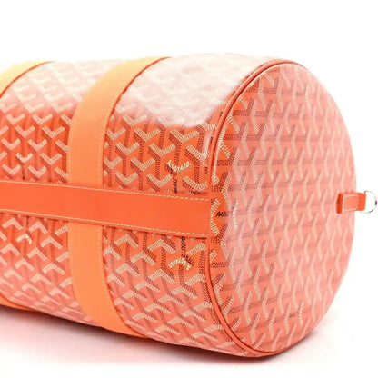 Orange monogram canvas barrel sports bag with side zip and strap D-ring detail.