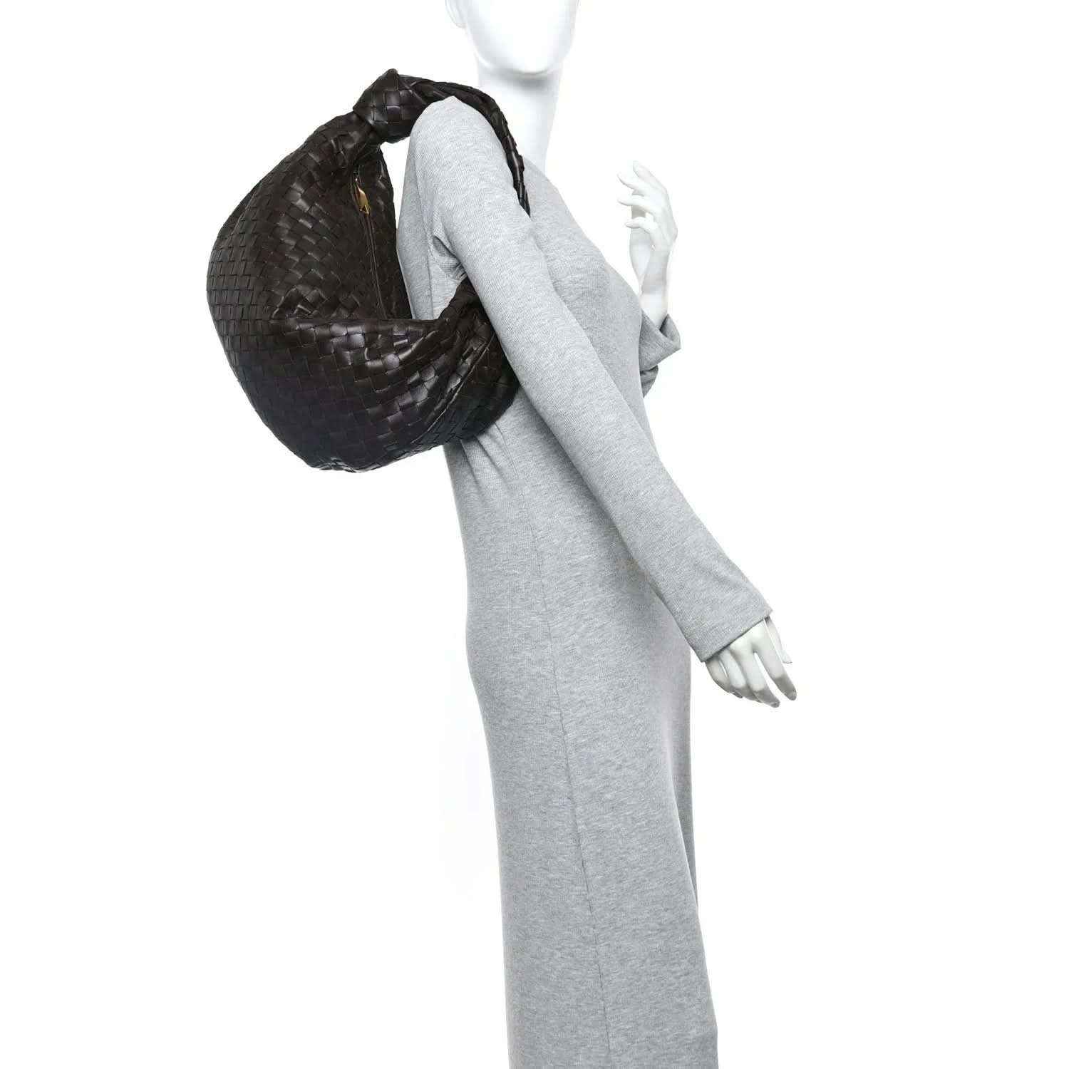 Small intrecciato leather Jodie bag held over shoulder, woven hobo silhouette