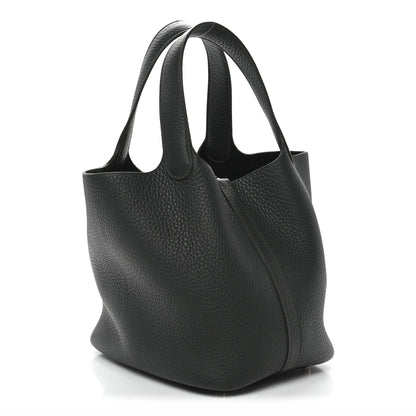 Textured dark green mini tote bag with open top and gold-tone front lock detail.