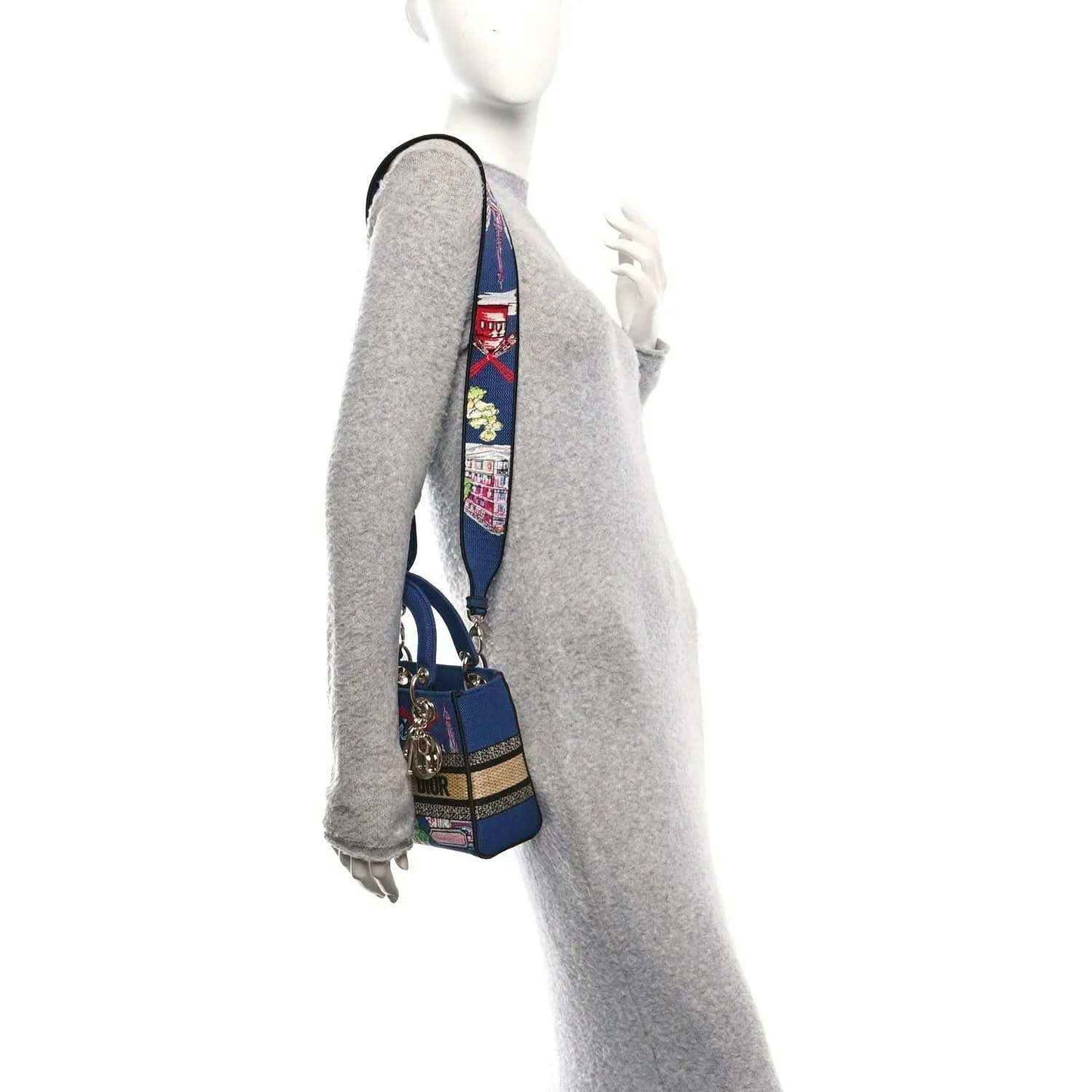 Blue small handbag on a wrist strap with embroidered Paris scenes and gold hardware