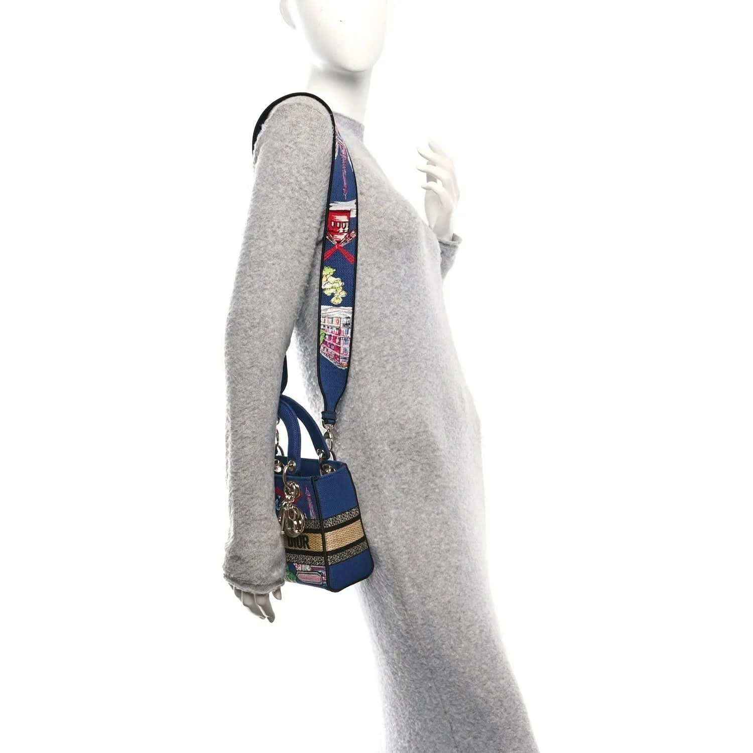 Blue small handbag on a wrist strap with embroidered Paris scenes and gold hardware