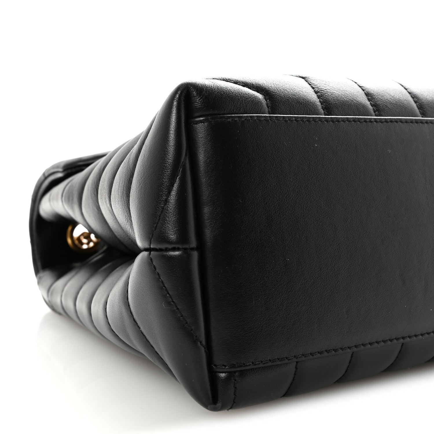 Black quilted satchel corner with stacked chevron stitching.