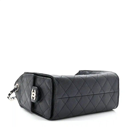 Quilted mini handbag rear view with corner flap and silver-tone hardware