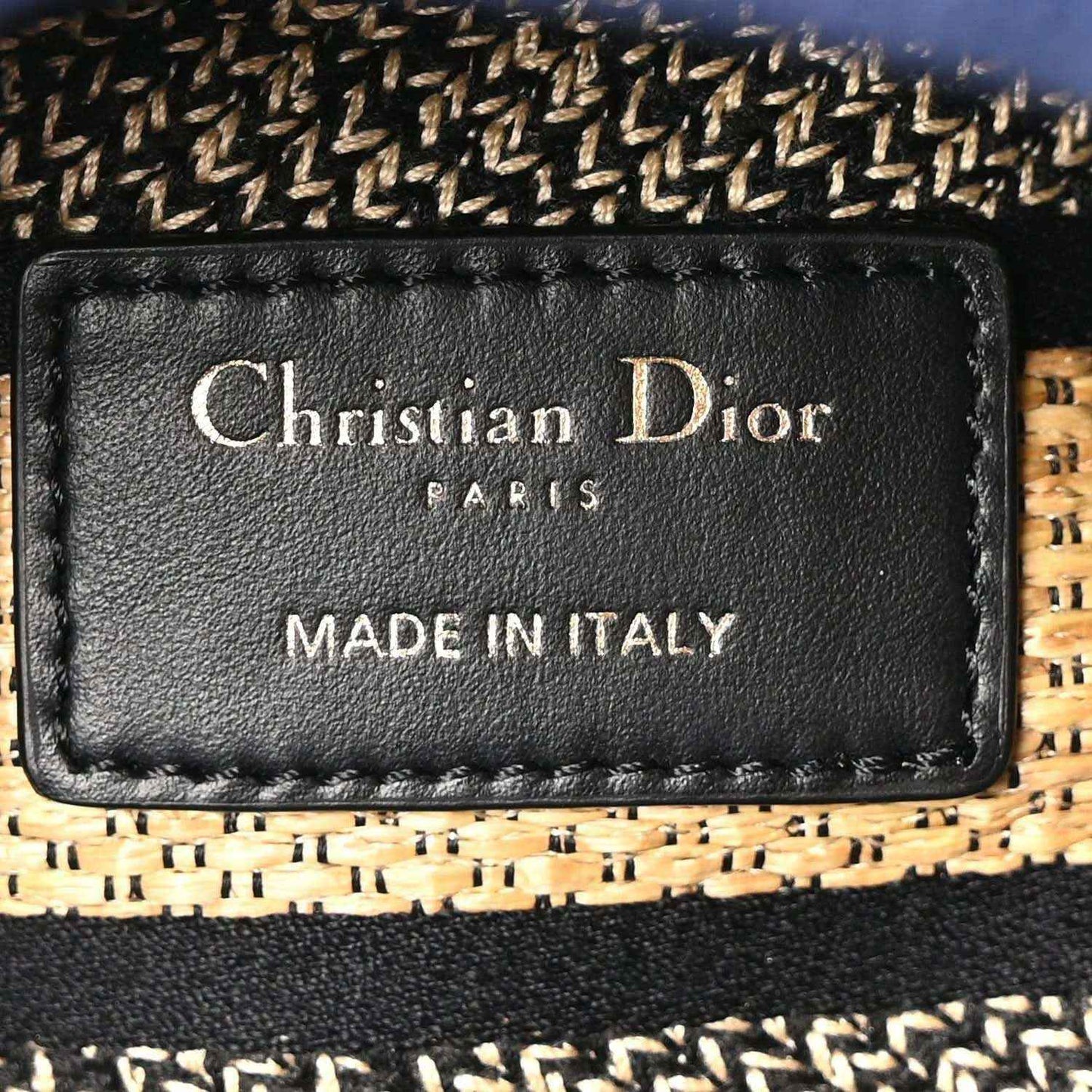 Black leather brand label reading Christian Dior Paris Made in Italy