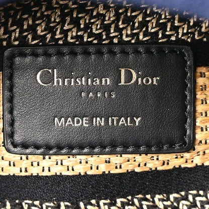 Black leather brand label reading Christian Dior Paris Made in Italy