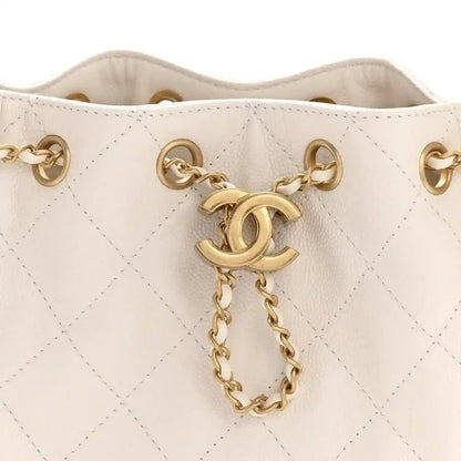 White quilted mini handbag opening with gold chain and CC-style charm