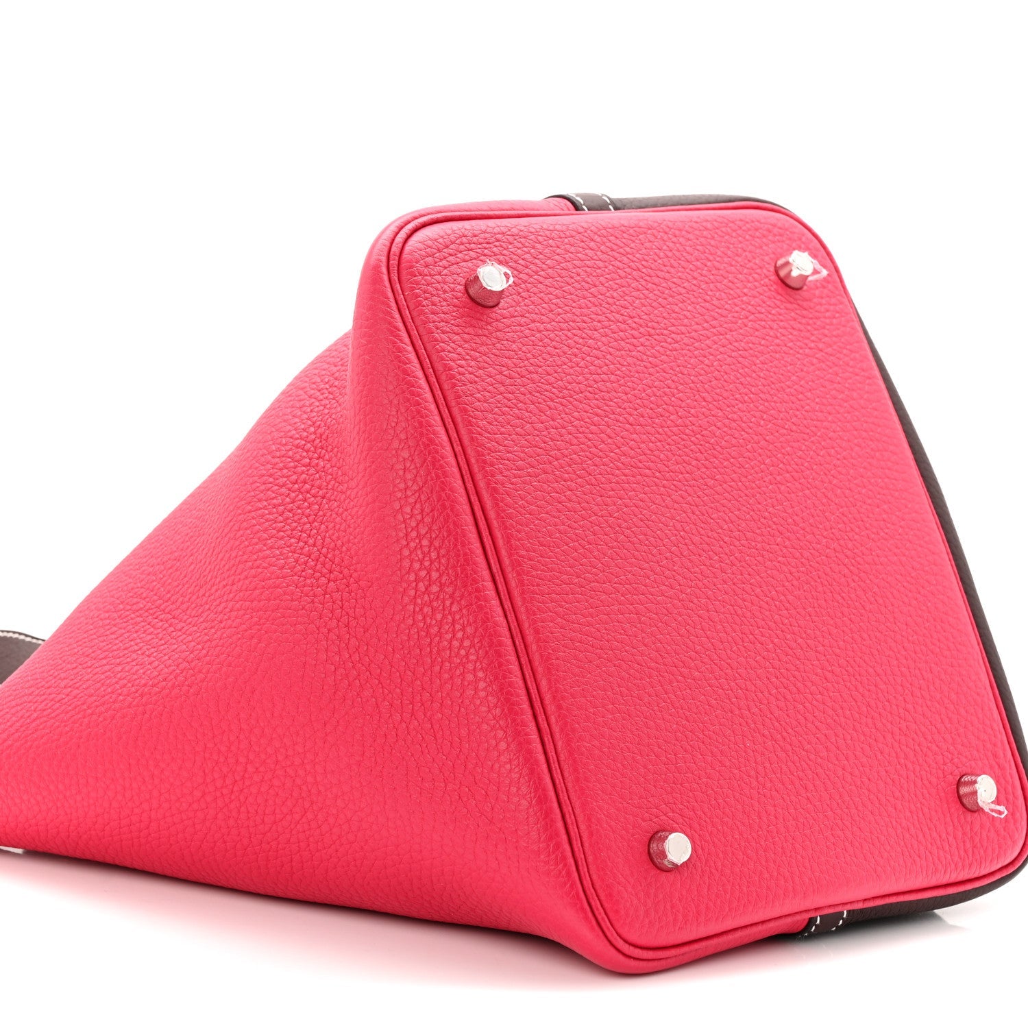 Bright red bucket bag with dark brown trim and silver-tone corner studs