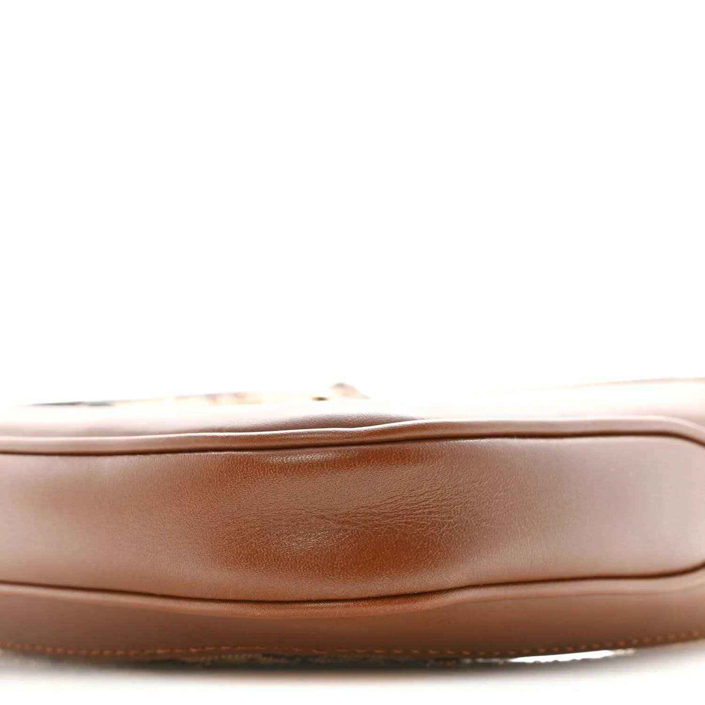 Mini hobo bag side panel close-up, smooth tan leather with curved seam and stitching
