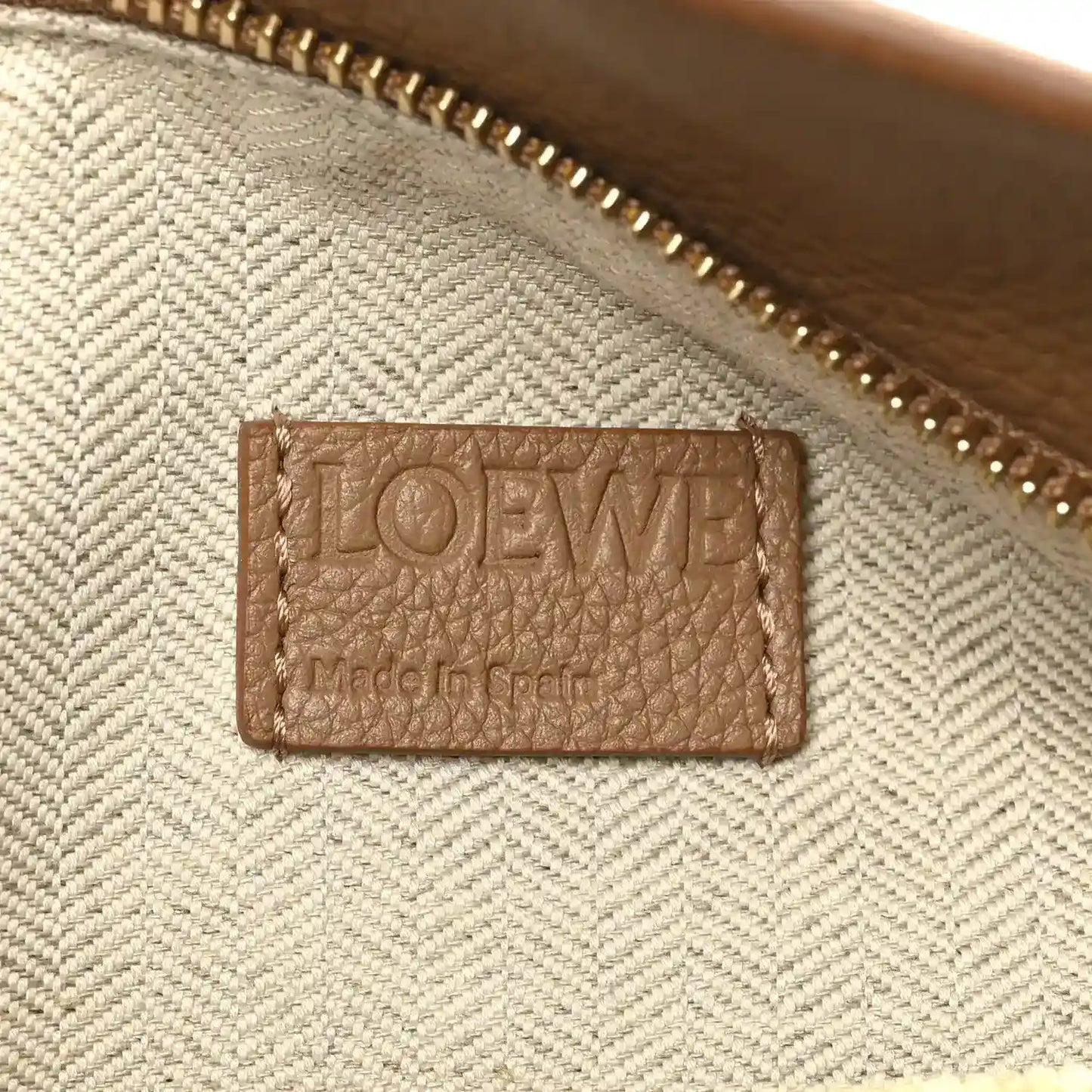 Loewe leather label inside small Puzzle Edge bag near gold zipper