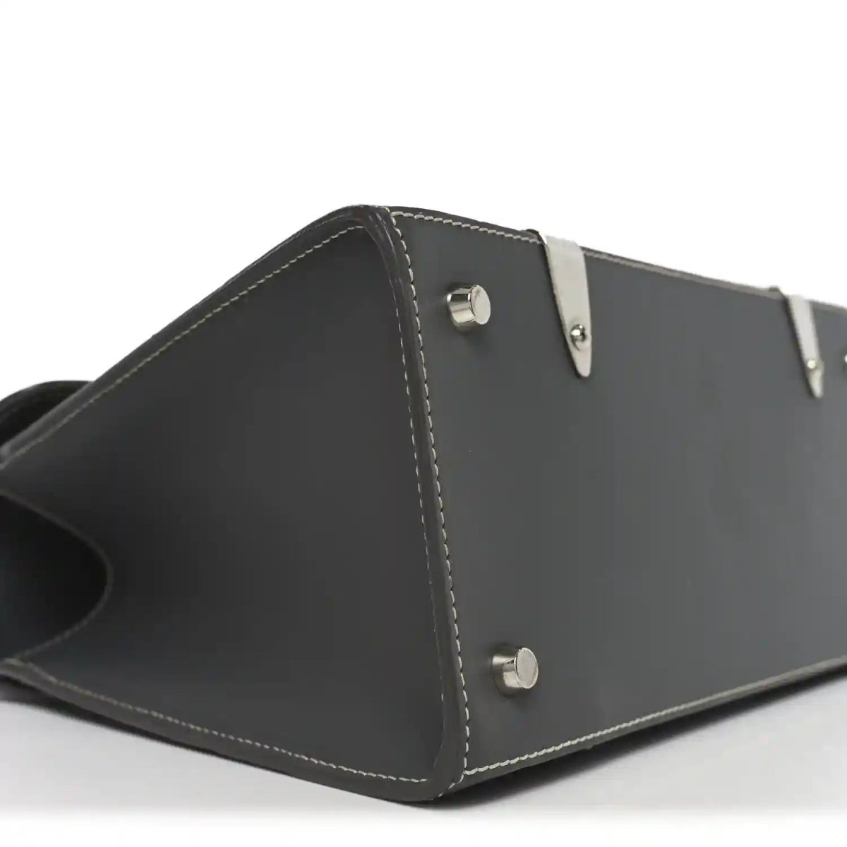 Black leather side panel with two metal snap buttons and contrast stitching