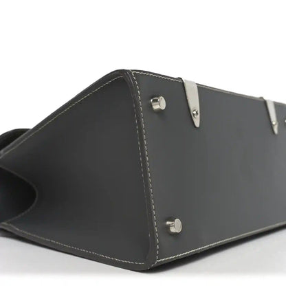 Black leather side panel with two metal snap buttons and contrast stitching