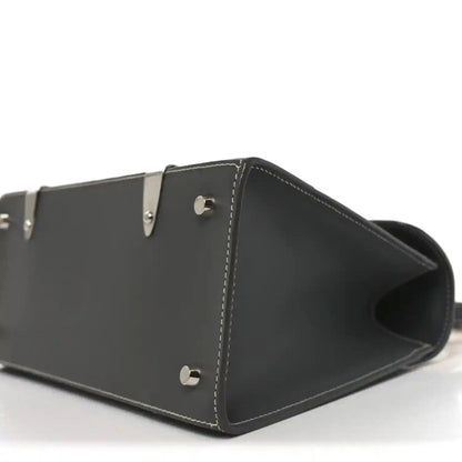 Black leather bag with open top, metal snap on side, and stitched trim