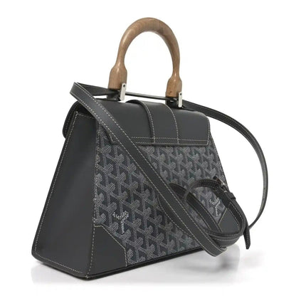 Grey canvas top-handle bag with black leather flap and shoulder strap, wood handles