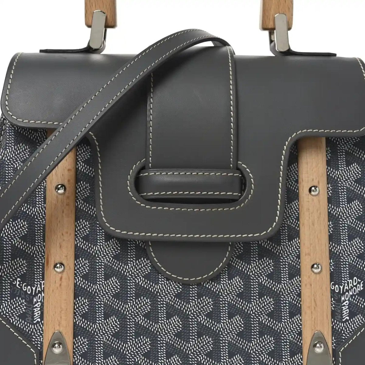 Grey canvas and black leather flap bag with wood handle mounts and stitched detail