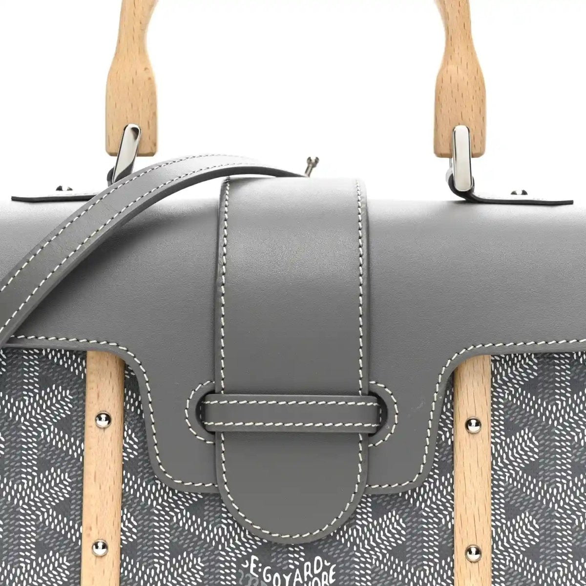 Grey mini Saigon bag front close-up with clasp flap, patterned canvas and stitched trim.