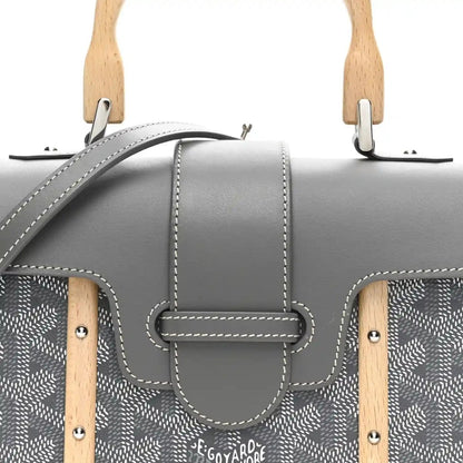 Grey mini Saigon bag front close-up with clasp flap, patterned canvas and stitched trim.