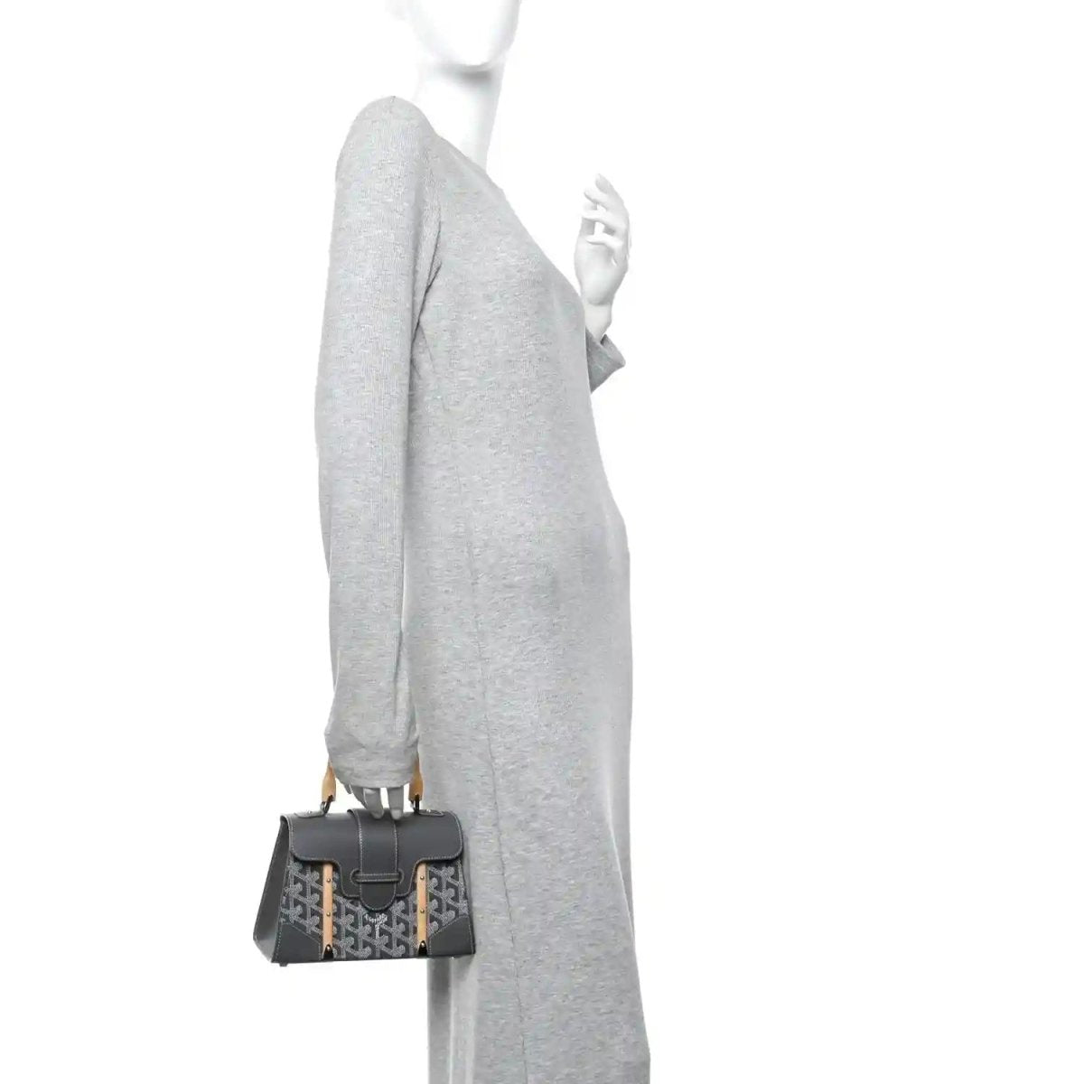 Grey mini Saigon bag on shoulder strap, patterned flap and leather edges.