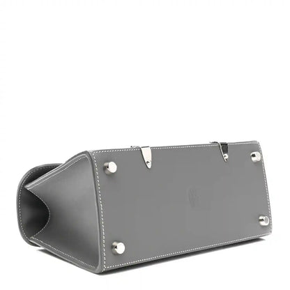 Grey leather mini Saigon bag bottom with metal studs and side seam stitching.