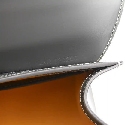 Grey leather mini Saigon bag close-up of interior marking and crossbody strap.