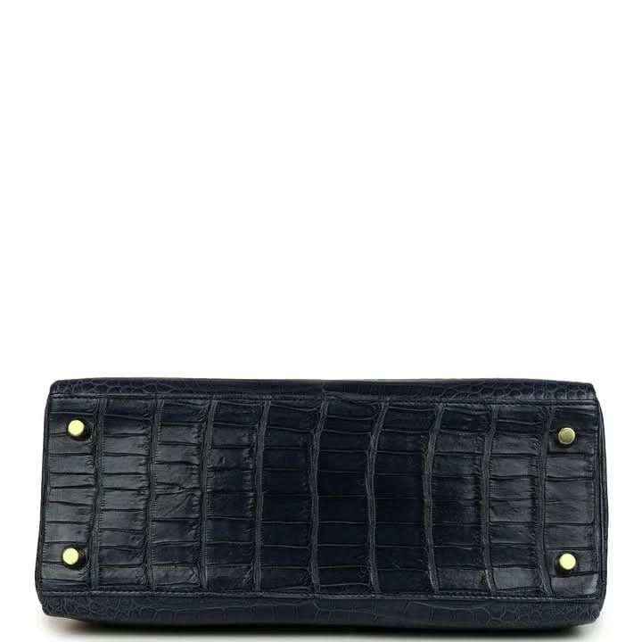 Hermès Kelly Retourne 28 bag close-up of front clasp and matte croc-embossed dark blue