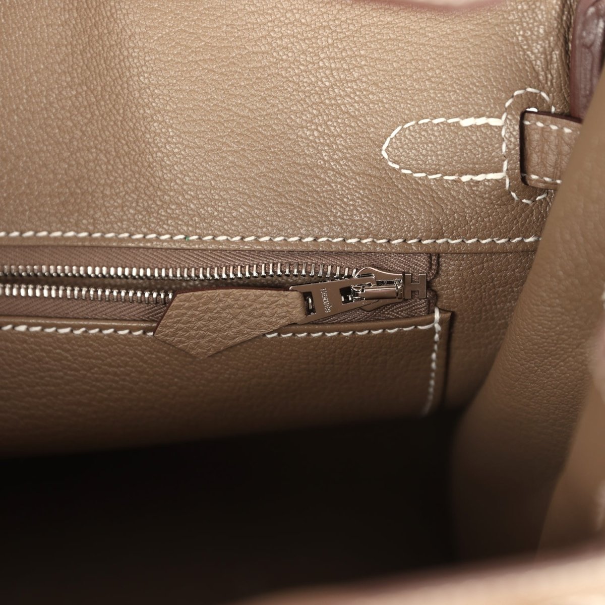 Hermes Birkin 25 leather interior close-up with zipper track and small hardware tab