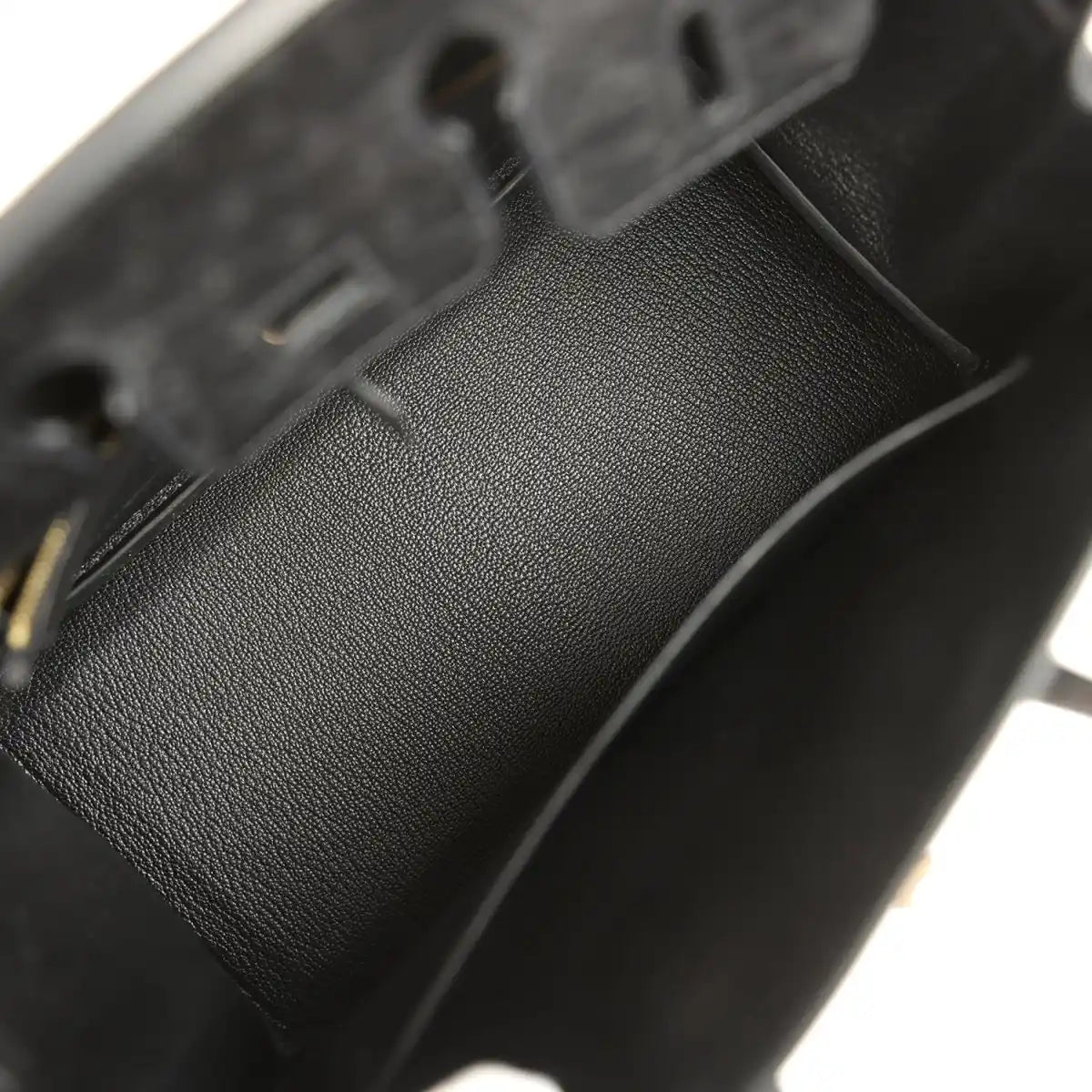 Black leather interior lining with stitched seam and pebbled texture