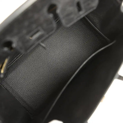 Black leather interior lining with stitched seam and pebbled texture