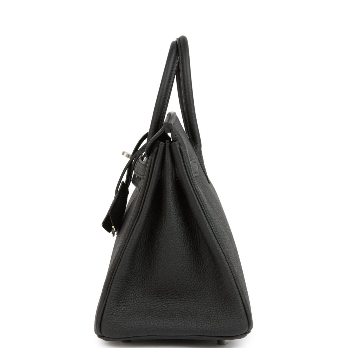 Black leather Birkin handbag from side view with top handles and minimal exterior hardware.