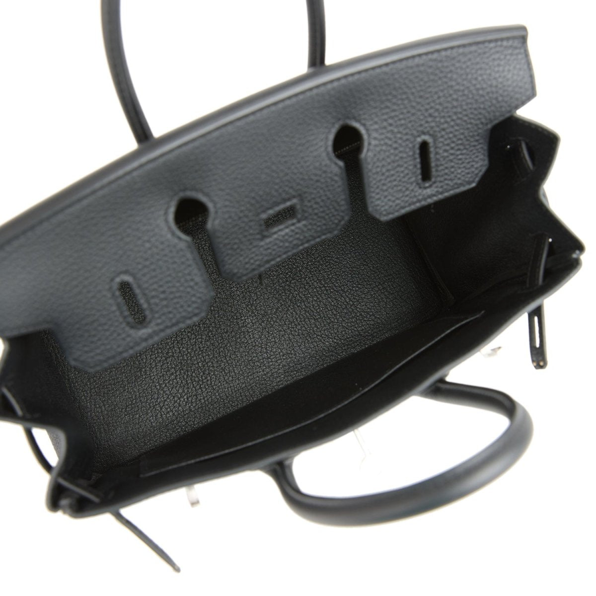 Black leather handbag base with embossed side feet and protective edge hardware.