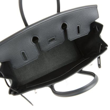 Black leather handbag base with embossed side feet and protective edge hardware.
