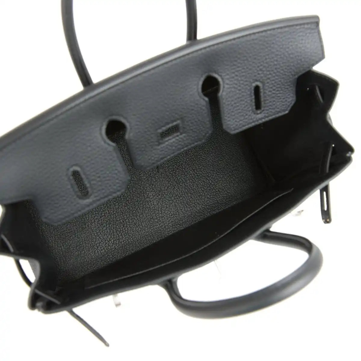 Black leather handbag base with embossed side feet and protective edge hardware.