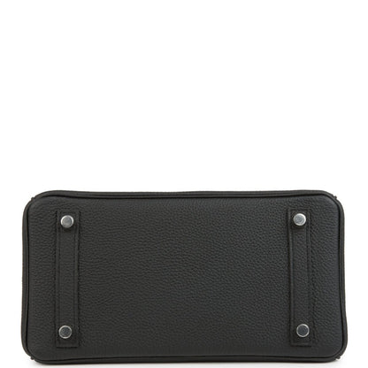 Black rectangular leather handbag front panel with snap posts and top stitching.