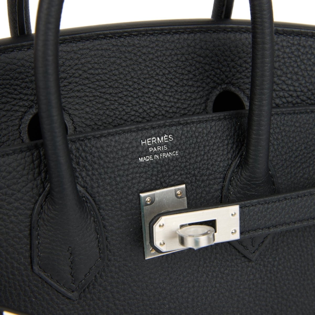 Black leather interior pocket with engraved brand plate and brushed palladium frame.