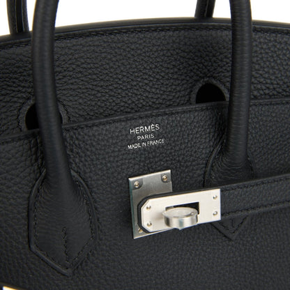 Black leather interior pocket with engraved brand plate and brushed palladium frame.