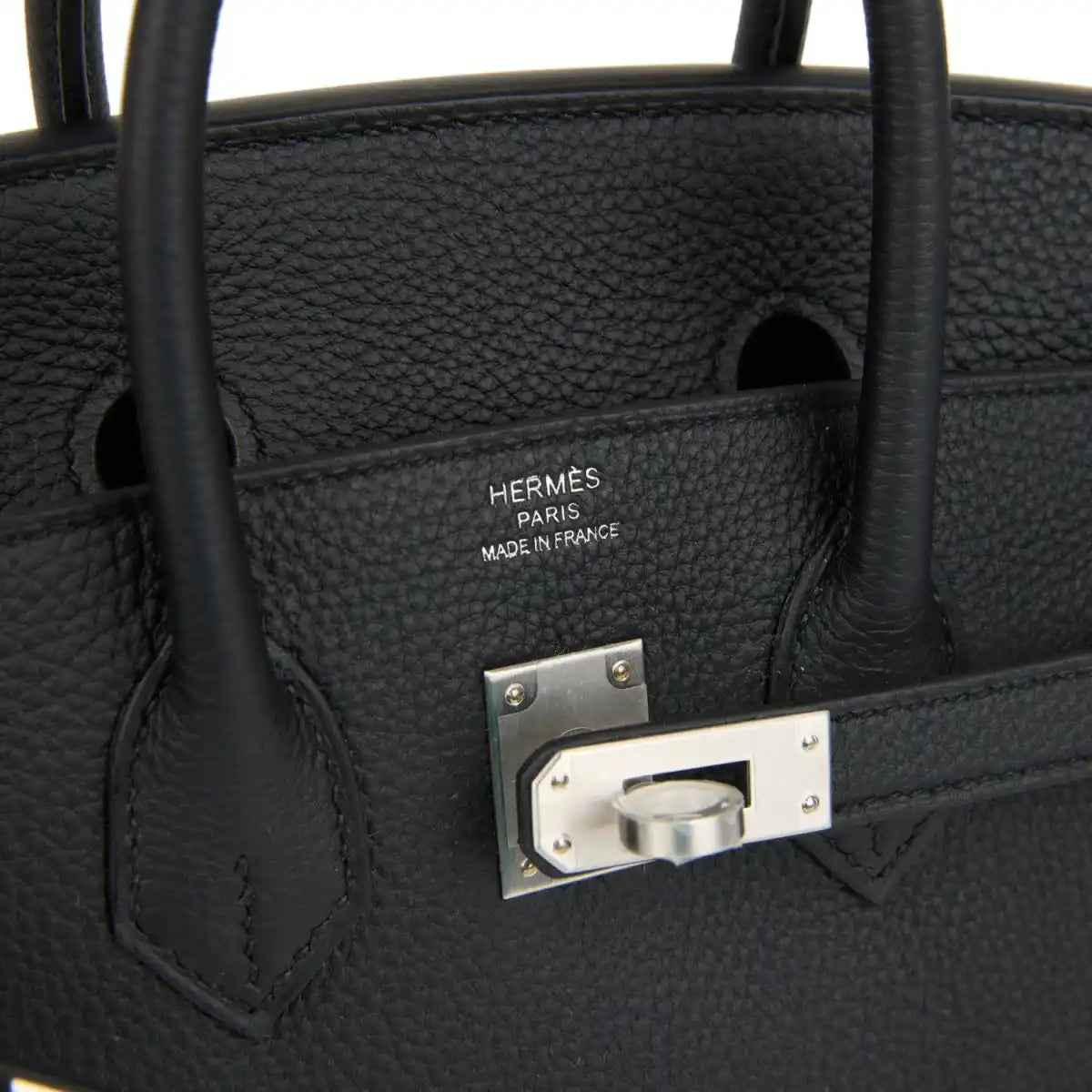 Black leather interior pocket with engraved brand plate and brushed palladium frame.