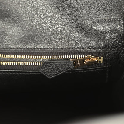 Black leather handbag interior with gold zipper and pull tab