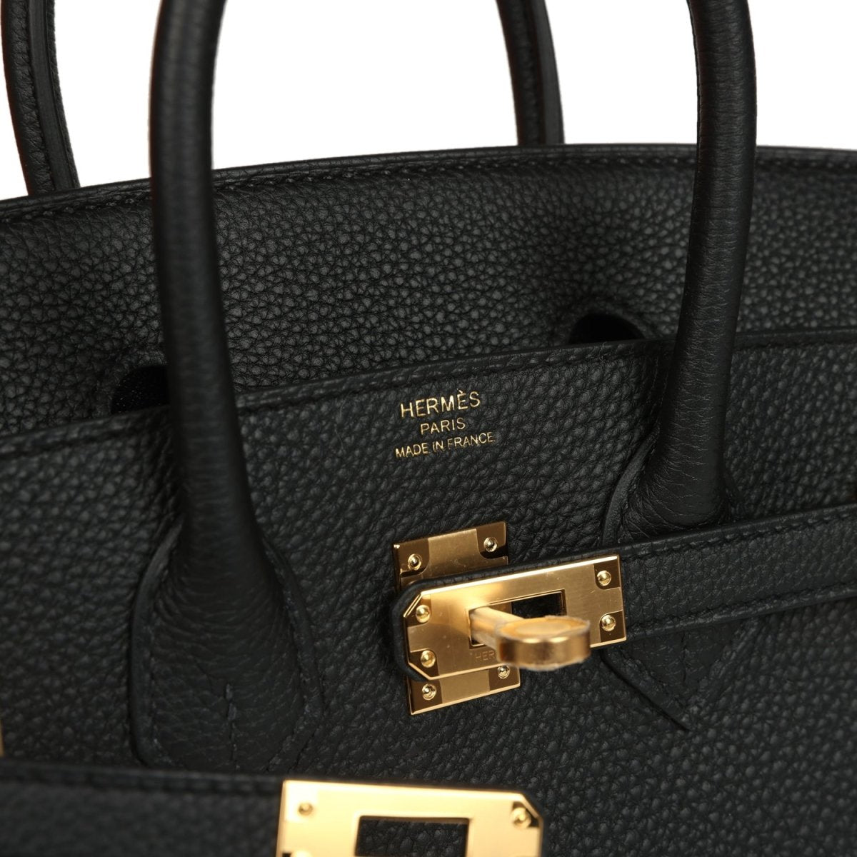 Black leather handbag with HERMÈS PARIS mark and gold turn-lock clasp