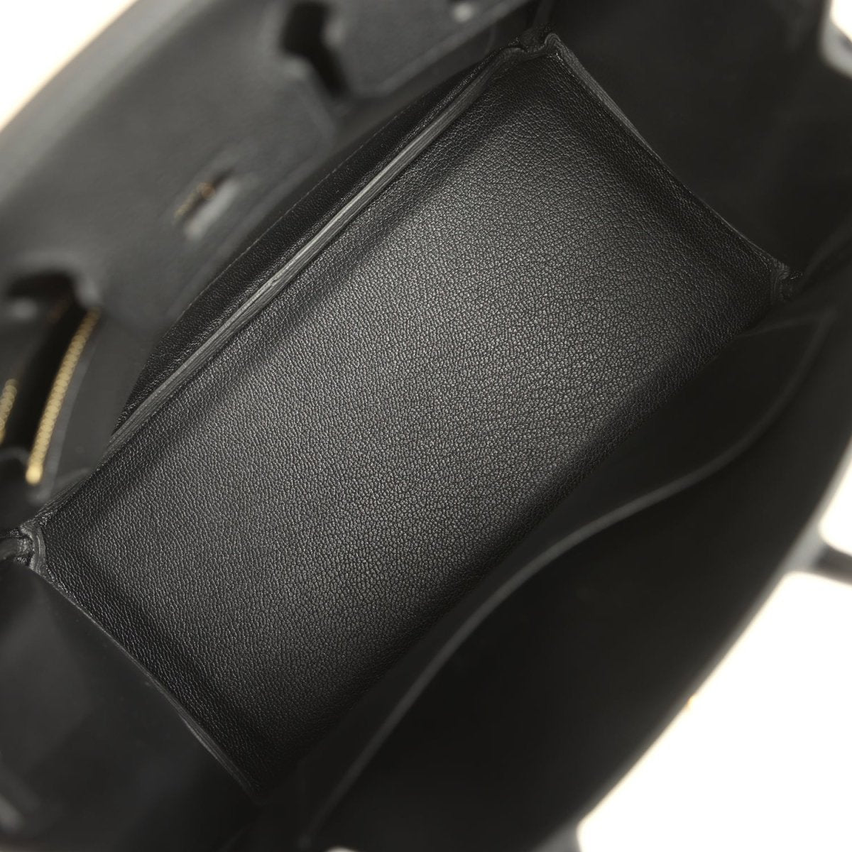 Black leather handbag interior pocket detail with textured lining